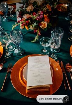 the table is set with gold and green place settings