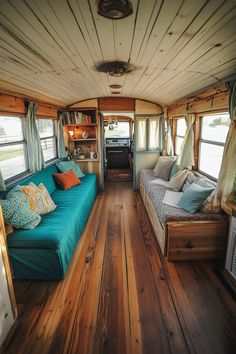 a living room with wood flooring and blue couch in the middle of the room