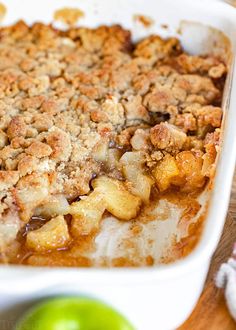 a casserole dish with apples and crumbled topping