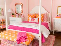 a bedroom with pink walls, white furniture and a chandelier hanging from the ceiling