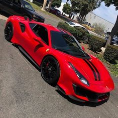 a red sports car is parked on the street