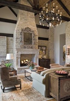 a living room filled with furniture and a fire place in the middle of a room