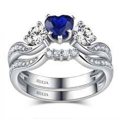 a heart shaped blue sapphire engagement ring set with two matching wedding bands and diamond accents