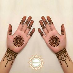 two hands with hendi designs on them