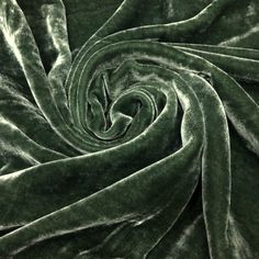 a close up view of a green velvet fabric