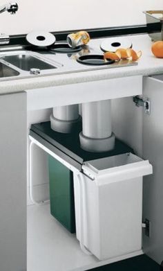 an image of a kitchen with trash cans in it