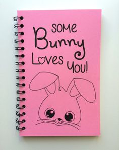 a pink notebook with some bunny loves you written on it