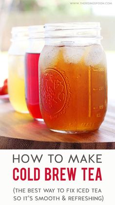 three jars filled with cold drinks sitting on top of a wooden table