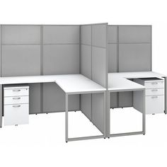 an office cubicle with three separate workstations and two file cabinets on each side