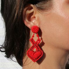 "Red XOXO heart earrings perfect for Valentine's day date outfits and gifts for a girlfriend or daughter that loves statement fashion pieces. Hand beaded lightweight earrings crafted by the female artisans from the indigenous Embera tribe of Columbia. Materials: Red glass Beads, metal set crystals, Surgical steel posts Measurements: Width: 2\" Length: 2.25\" Weight: 0.6 oz Hyperallergenic Post back Closure About the brand partner: Treasure Jewels is a small family owned, fair trade jewelry brand based in Colombia. Each piece is crafted by a local group of female Colombian artisans and jewelers, many of whom are single mothers seeking to support their families. By supporting these talented artisans with more than living wages, we create significant economic impact for this community of arti Red Heart Beads Jewelry For Summer, Handmade Red Heart Earrings, Red Beaded Earrings For Summer, Red Heart Beads Earrings For Party, Red Handmade Heart Earrings For Party, Elegant Heart Beads Earrings For Valentine's Day, Valentine's Day Beaded Earrings For Pierced Ears, Red Heart Bead Drop Earrings, Red Heart Beads Drop Earrings