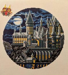 a cross stitch picture of hogwart's castle in the night with a full moon behind it