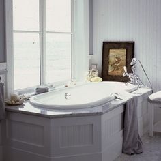 a white bath tub sitting next to a window