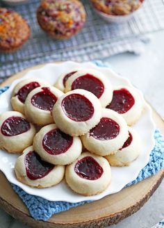 some cookies are on a plate with jam