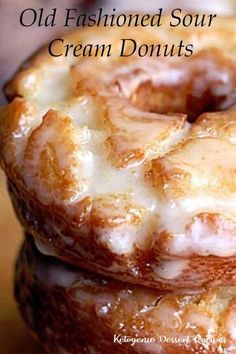 two glazed donuts stacked on top of each other with icing and glaze