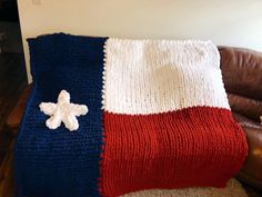 a red, white and blue blanket sitting on top of a couch