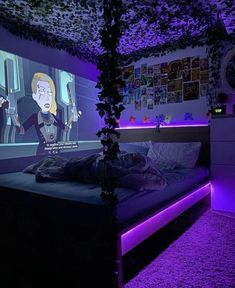 a bed in a room with purple lights on the ceiling and a cartoon character projected on the wall