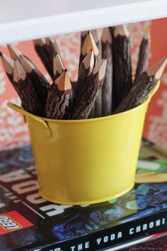 several pencils are in a yellow cup