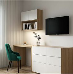 a tv mounted on the wall above a desk with a green chair and bookcase