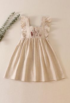 This beige floral embroidered ruffle dress is made from soft linen, perfect for little girls who love comfort and style. Featuring delicate floral embroidery and charming ruffle details along the sleeves and hem, this dress is ideal for any special occasion or everyday wear. Its lightweight, breathable fabric ensures all-day comfort while the timeless design adds a touch of elegance. Dresses With Embroidery, Sequin Crafts, Ruffle Linen, Plaid And Leopard, Beige Dress, Beige Dresses, Loungewear Sets, Sequins Embroidery, All Eyes