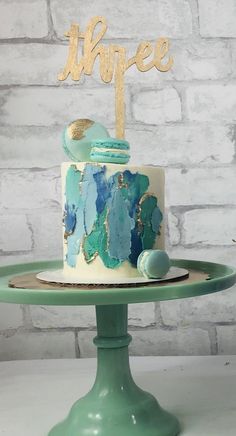 there is a cake that has been decorated with blue and green icing on it