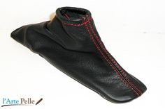 a pair of black leather shoes with red stitching on the soles and heel