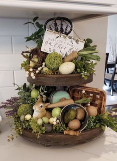 three tiered trays filled with different types of vegetables and fruits on top of a counter