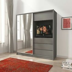 a large mirror in the middle of a room with a man and woman on it