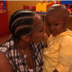 a woman holding a small child in her lap