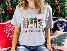 Christmas movie friends Bella Canvas Shirt This classic unisex jersey short sleeve tee fits like a well-loved favorite. Soft cotton and quality print make users fall in love with it over and over again. These t-shirts have-ribbed knit collars to bolster shaping. The shoulders have taping for better fit over time. Dual side seams hold the garment's shape for longer. .: 100% Airlume combed and ringspun cotton (fiber content may vary for different colors) .: Light fabric (4.2 oz/yd² (142 g/m .: Ret Casual Christmas Fan Merchandise Tops, Christmas Fan Merchandise Crew Neck Tops, Home Alone Kevin, Buddy Elf, Clark Griswold, Family Matching Christmas, Buddy The Elf, Funny Family, Family Funny