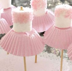 pink cupcakes with white frosting on sticks