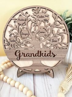 a wooden plaque with the words grandkids on it next to a bead necklace