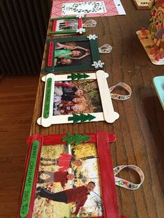 a table topped with pictures and frames covered in christmas decorations on top of a wooden table