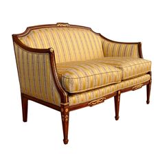 an old fashioned chair with striped upholstered fabric and wood trimming on the legs