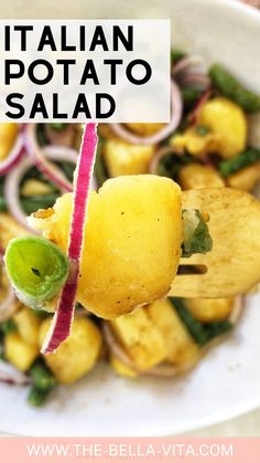 a close up of food on a fork with the words italian potato salad above it