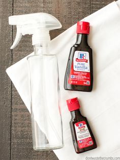 two bottles of cleaner and a bottle of mouthwash sitting on top of a white cloth