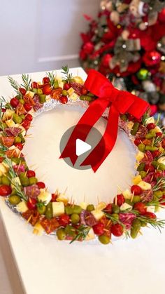 a christmas wreath on a table with a red ribbon