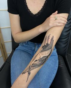 a woman with a bird tattoo on her arm