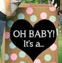 a woman holding a cardboard bag with polka dots and the words oh baby it's a