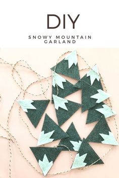 the snow mountain garland is made out of green felt and has white arrows on it