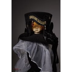 A hat with a strange doll's head placed in the middle. It features a tall crown and is decorated with lace embroidery and ribbons. Let yourself be invited to a mysterious and dark world. 
 
 

 

 
 
 
 Size 
 
 Height: 14cm 
 Diameter: 17cm (*Size not including brim) 
 Diameter: 24cm (*Size including brim) 
 
 
 Material 
 
 Polyester 
 velvet Whimsical Costume Hat With Tall Crown For Costume Party, Whimsical Costume Hat With Tall Crown For Parties, Whimsical Tall Crown Costume Hat For Costume Party, Victorian High Crown Costume Hat, Whimsical High Crown Costume Hat, Carnival Costume Top Hat With High Crown, High Crown Hats For Carnival Costume, High Crown Top Hat For Halloween, High Crown Top Hat For Carnival Costume