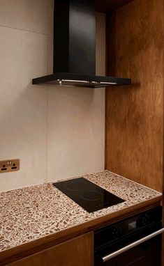 a stove top oven sitting inside of a kitchen next to a wall mounted range hood