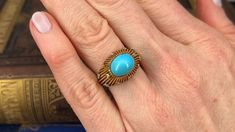 This stunning ring features an open wirework design is centered with an oval turquoise cabochon atop a domed starburst. The top of the ring is bead set with twelve (12) round single cut diamonds. The ring measures 12.9mm at the top, rises 10.5mm above the finger, tapering to 3.2mm wide and 1.2mm thick at the base of the shank. The ring is crafted in 18k yellow gold with a great patina, and it is currently a size 6. The turquoise is secured with jewelers epoxy. Heirloom Style Cabochon Turquoise Ring For Formal Occasions, Elegant Oval Cabochon Turquoise Ring For Formal Events, Elegant Oval Cabochon Turquoise Ring For Formal Occasions, Formal Oval Cabochon Turquoise Ring, Formal Fine Jewelry Turquoise Cabochon Ring, Formal Turquoise Cabochon Ring Fine Jewelry, Formal Turquoise Cabochon Ring, Formal Heirloom Turquoise Cabochon Ring, Formal Cabochon Turquoise Ring