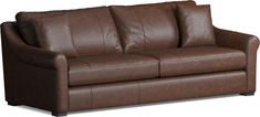 a brown leather couch sitting on top of a white floor