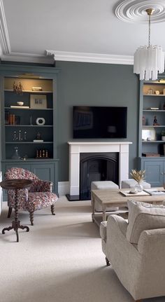 a living room filled with furniture and a flat screen tv mounted on a wall above a fire place