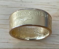 a gold ring with the words united states of liberty engraved on it's side