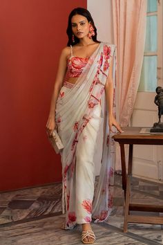 Off white predraped pant saree in floral pattern. Paired with a sleeveless padded bustier.
Components: 2
Pattern: Embroidered
Type Of Work: Cutdana, Bead
Neckline: Plunging V
Sleeve Type: Sleeveless
Fabric: Chiffon
Color: Off White
Other Details: 
Back string tie-up
Attached lining
Closure:
Pant Saree: Half Elastic
Note: Clutch shown in the image is not for sale.
Occasion: Mehendi and Haldi, Destination Wedding - Aza Fashions Elegant Summer Pre-draped Saree With Dupatta, Bollywood Style Pre-draped Saree With Sheer Dupatta For Summer, Summer Reception Pre-draped Saree, Traditional Drape Sharara For Summer Reception, Traditional Pre-draped Saree For Summer Reception, Summer Reception Sharara With Traditional Drape, Summer Wedding Pre-draped Saree With Sheer Dupatta, Summer Choli With Sheer Dupatta In Traditional Drape, Summer Georgette Pre-draped Saree For Reception