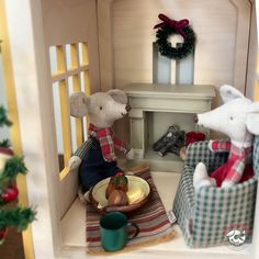 two teddy bears are sitting in their doll house