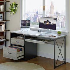 a desk with two computers on it in front of a window and bookshelf