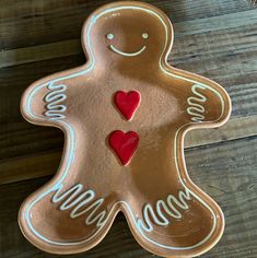 a cookie shaped like a ginger with hearts on it