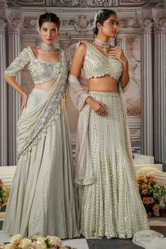 Grey mermaid cut lehenga with all over linear embroidery using sequins, crystals and beads. Paired with a coordinating blouse with scallop lace and dupatta with beaded border. - Aza Fashions Fitted Sleeveless Sharara For Wedding, Fitted Sleeveless Lehenga With Sheer Dupatta, Fitted Bodice Sets For Reception, Floor-length Lehenga With Fitted Bodice, Fitted Lehenga With Mirror Work, Wedding Choli With Fitted Bodice, Fitted Gown With Sheer Dupatta, Elegant Fitted Sleeveless Lehenga, Festive Reception Sets With Fitted Bodice